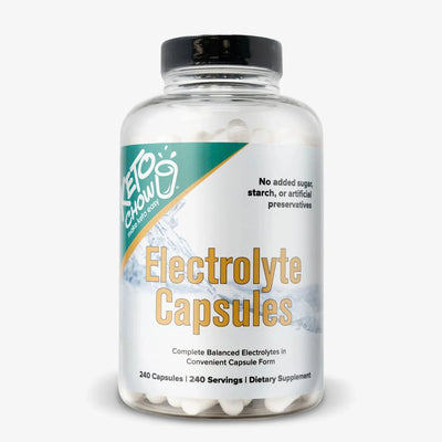 Clear bottle of Keto Chow Electrolyte Capsules - 240 Serves with white capsules and label highlighting balanced electrolytes and no added sugar