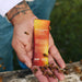 Beekeeper holding a Sodii Raw Electrolyte Honey sachet