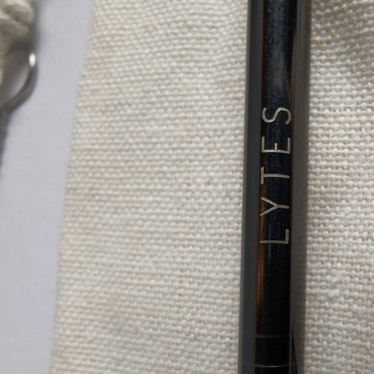 Close-up of the LYTES logo engraved on a black stainless steel straw