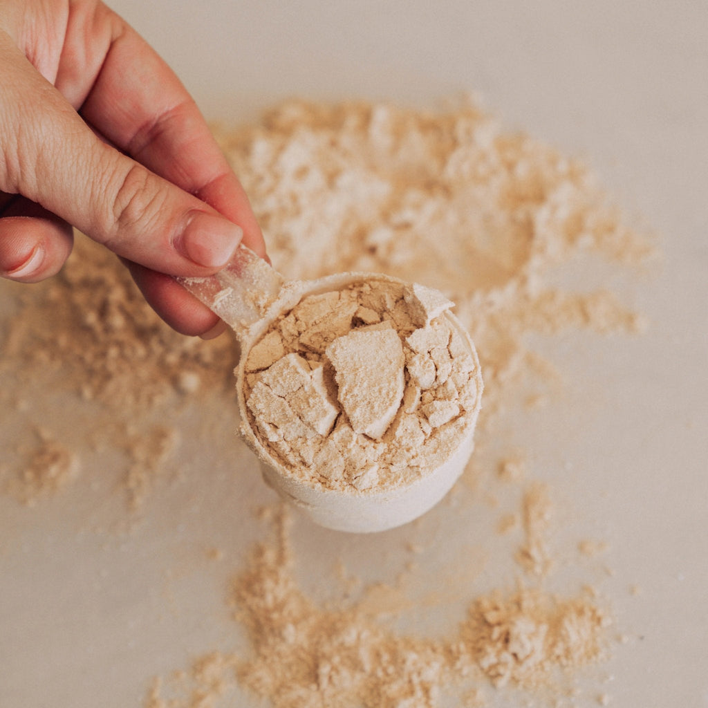 Hand holding a scoop of Beef Protein Isolate - Iced Latte - 450g powder by Switch Nutrition, New Arrivals collection.