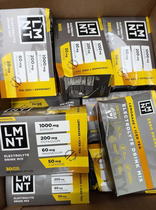Multiple boxes of Lemonade + Iced Tea - 30 Sticks - Damaged Box electrolyte drink mix by LMNT stacked in a cardboard box
