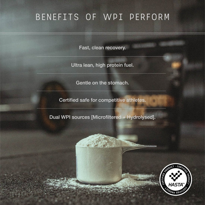 A scoop of Switch Nutrition Perform Whey Protein Isolate - Chocolate 750g sits on a gym floor with a barbell and protein container behind. Benefits: rapid absorption, high protein, gentle, athlete safe, lactose-free, dual WPI sources.