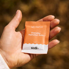 Hand holding a single sachet of Salty Grapefruit - 30 Sachets by Sodii from the Electrolytes and Low Carb collection