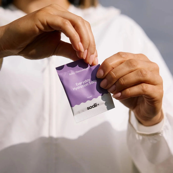 Person holding a purple sachet of Salty Passionfruit - 30 Sachets by Sodii from the Electrolytes collection